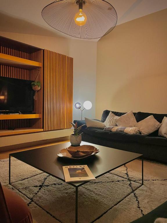 a living room with a couch and a coffee table at Maï Homes - La Villa Bompard in Marseille