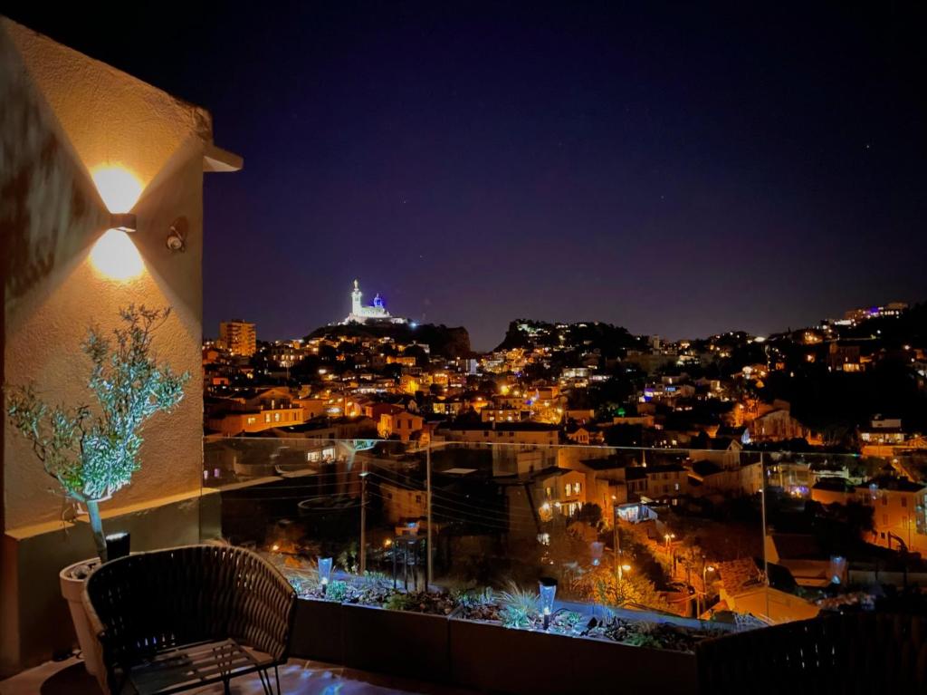 a view of a city at night from a balcony at Maï Homes - La Villa Bompard in Marseille