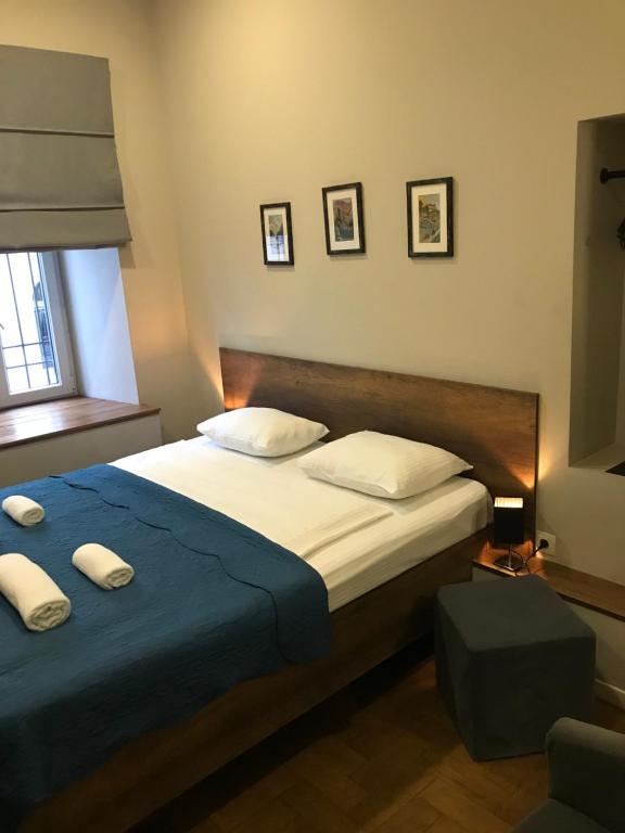 a bedroom with a large bed with a blue blanket at Hotel Loft in Tbilisi City