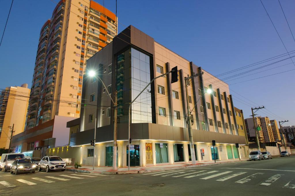 a city street with tall buildings and traffic lights at Hotel Olympia in Vila Velha