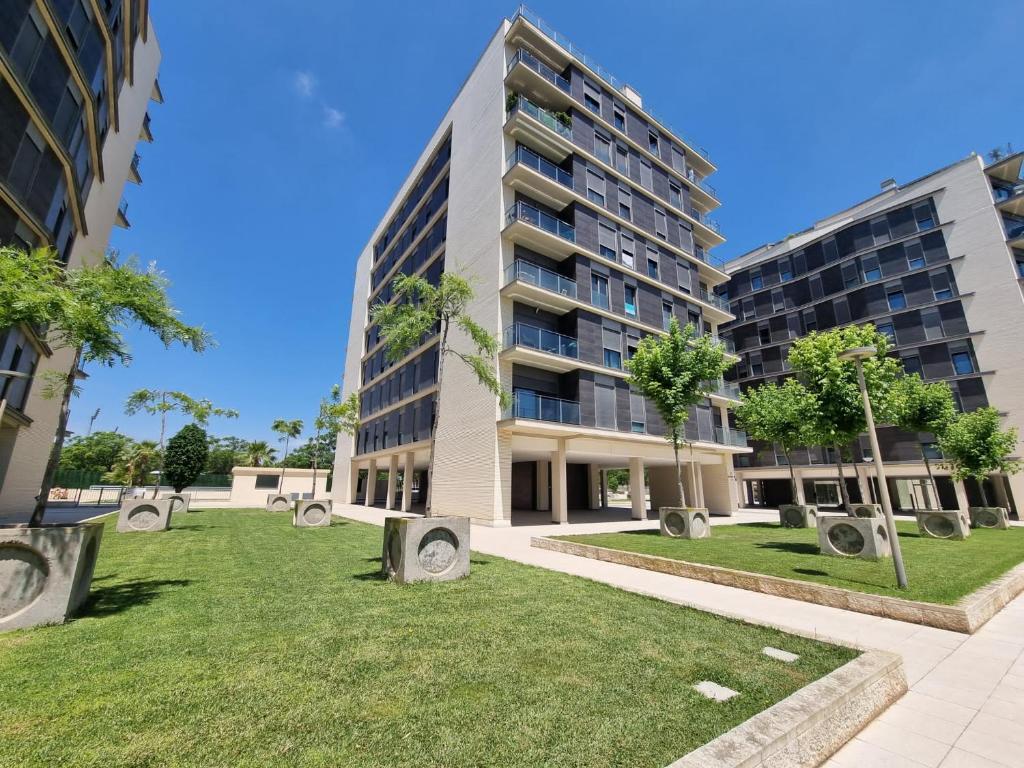 an apartment building with a park in front of it at APARTAMENTO CAMP DE MORVEDRE in Castellón de la Plana