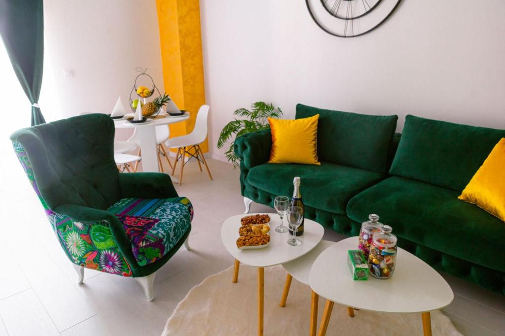 a living room with a green couch and two tables at Apartman GREEN in Brčko
