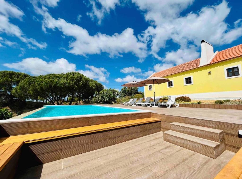 a backyard with a swimming pool and a house at Celestial Melides Country House in Melides