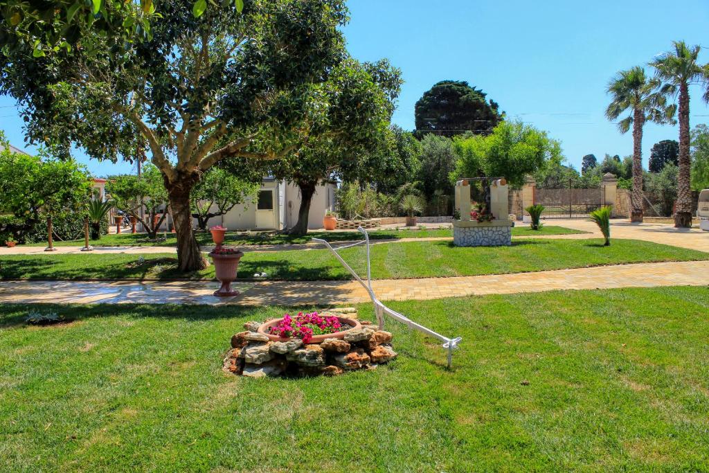 a garden with a flower bed in the grass at Tenuta Paifer in Otranto