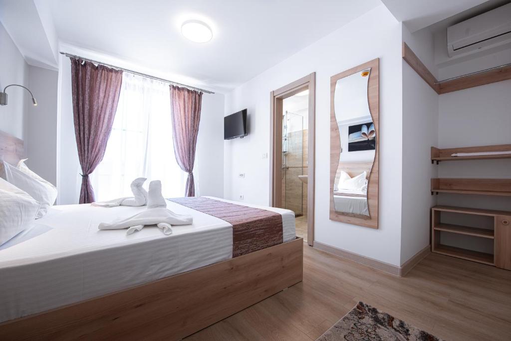 a bedroom with a large bed and a large window at Polu-X in Vama Veche