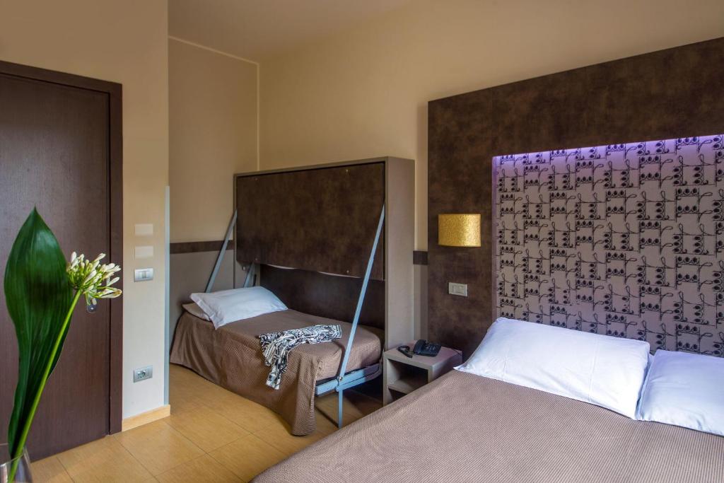 Postel nebo postele na pokoji v ubytování Hotel Dei Mille