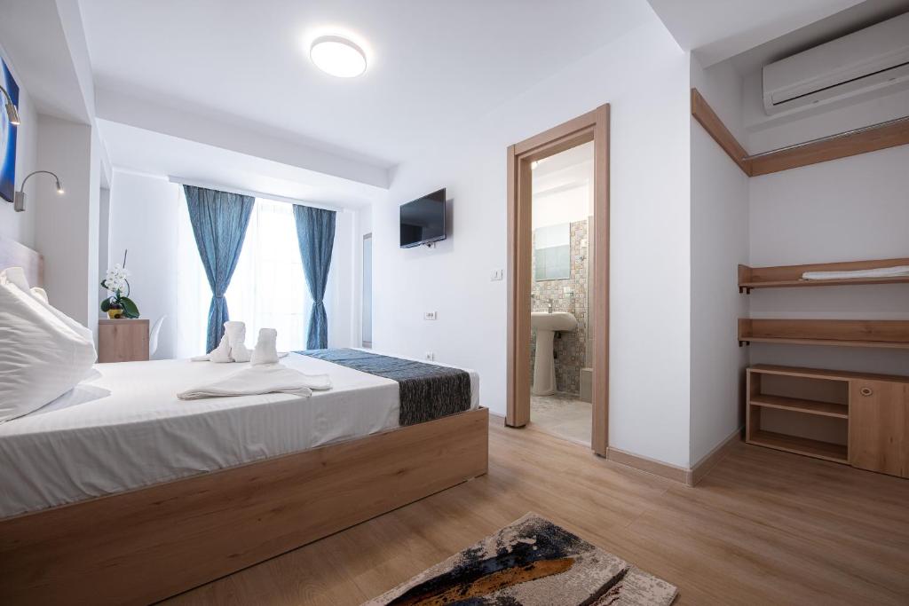 a bedroom with a large bed and a window at Polu-X in Vama Veche