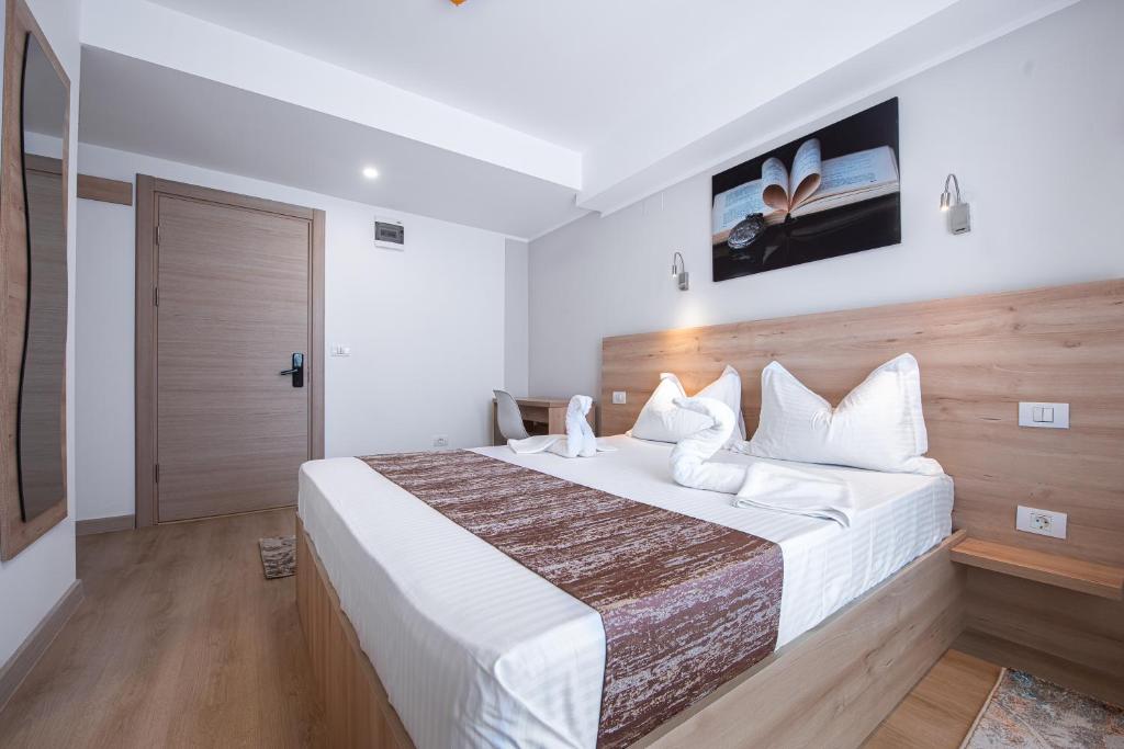 a hotel room with a large bed and a tv at Polu-X in Vama Veche