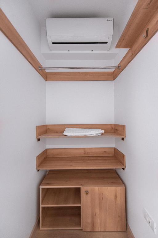 a room with wooden shelves and a ceiling at Polu-X in Vama Veche