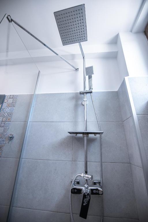 a shower in a room with a shower at Polu-X in Vama Veche