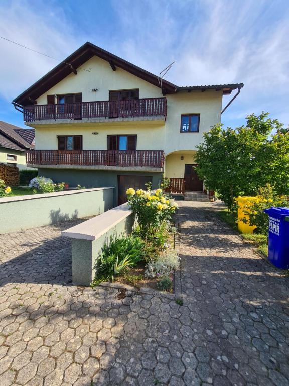 a house with a balcony on top of it at Apartman Bepo in Gospić