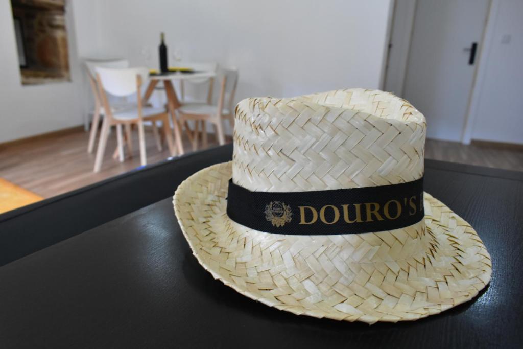 a straw hat sitting on top of a table at Douro Feels Like Home in Fontelo