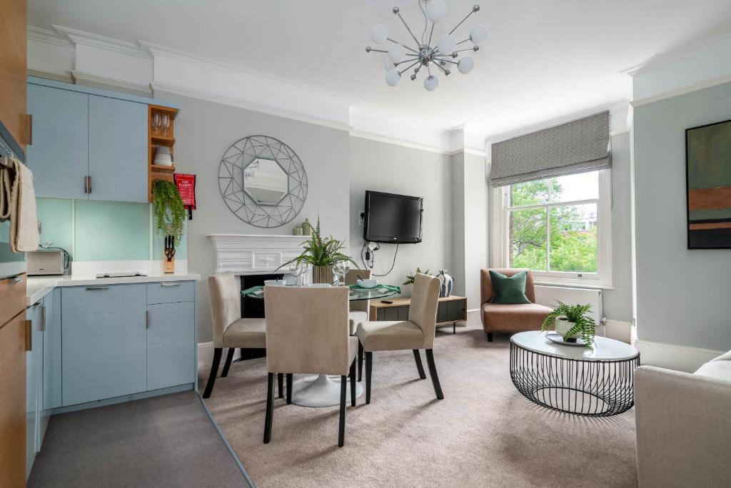 een keuken en een woonkamer met een tafel en stoelen bij 5 Doughty Street in Londen