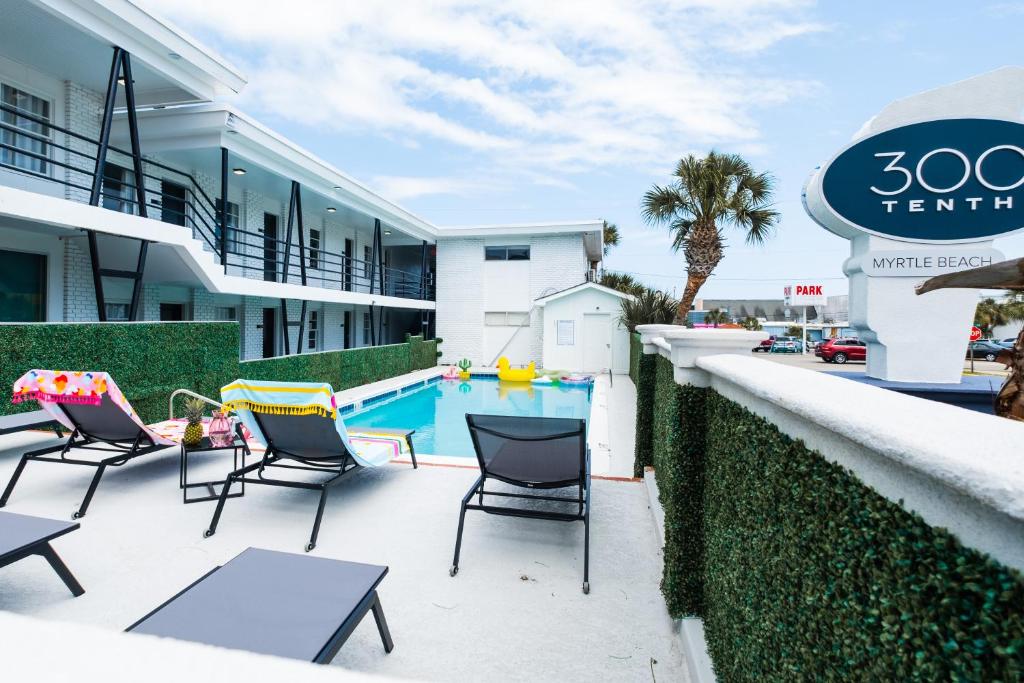 a patio with chairs and a swimming pool at 300 Tenth in Myrtle Beach