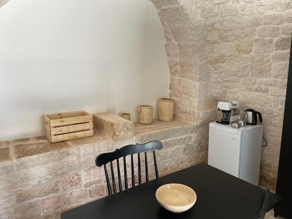 a table and a chair in a room at Masseria La Mandra in Noci