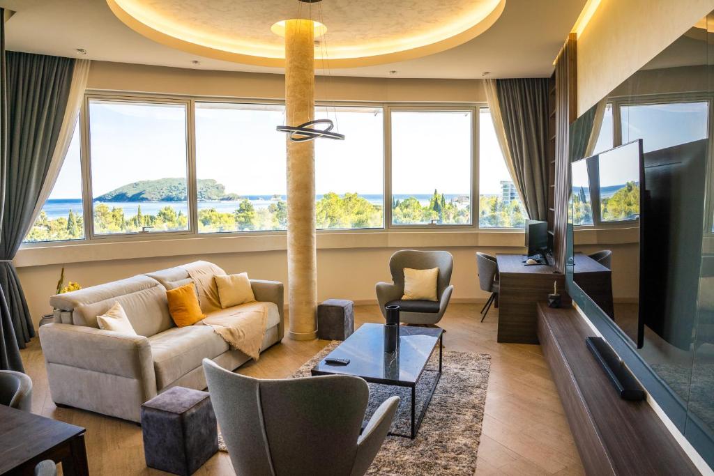 a living room with a couch and a tv at The Apartment - Luxury Stay Budva in Budva