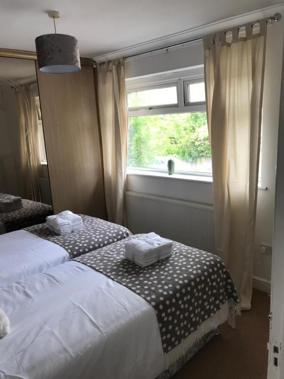 a bedroom with two twin beds and a window at 2Bed Bungalow House, Speedwell, Bristol, UK, sleeps up to 6 guests in Bristol