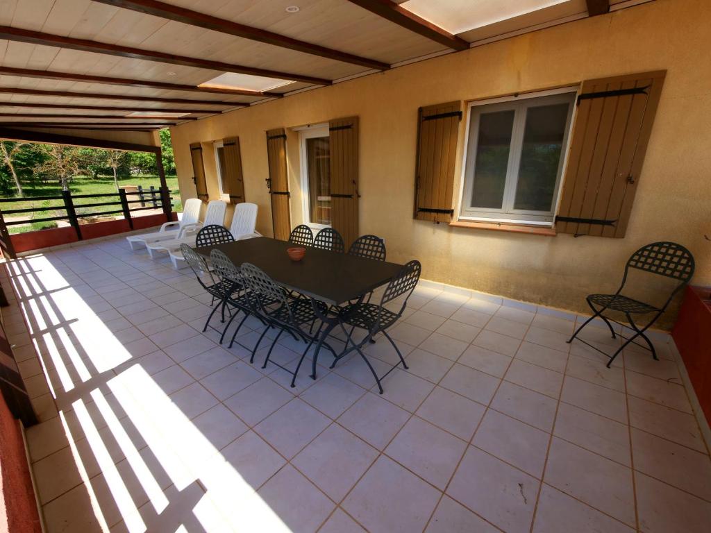 a patio with a table and chairs on it at Campagne SAINT MAURINET in Montmeyan
