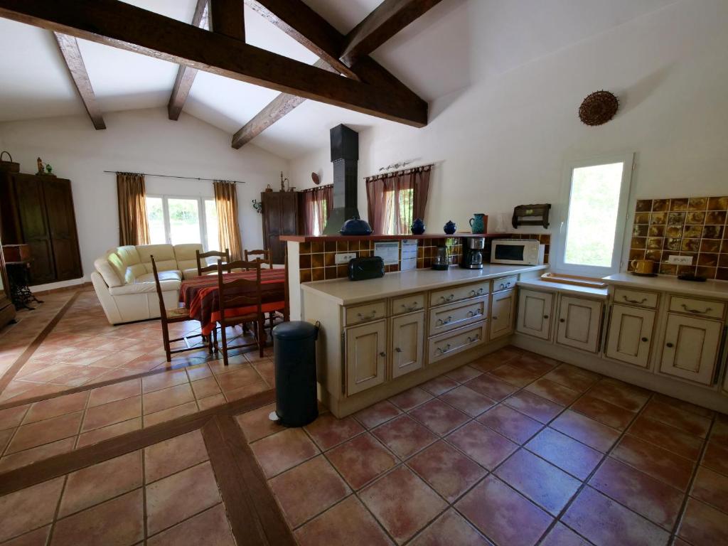 a large kitchen with a table and a couch at Campagne SAINT MAURINET in Montmeyan