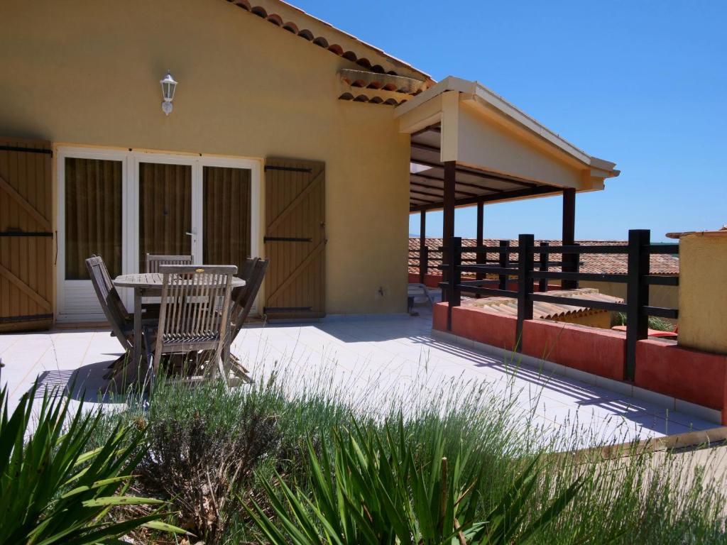 a patio with a table and chairs in front of a house at Campagne SAINT MAURINET in Montmeyan