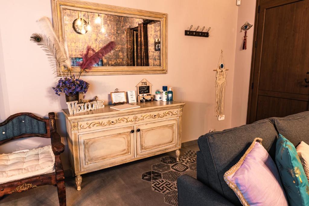 a living room with a couch and a wooden cabinet at Palmtrees Cottage in Lávrion