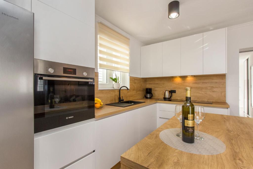 a kitchen with a bottle of wine on a counter at Holiday Home Lucia in Lozovac