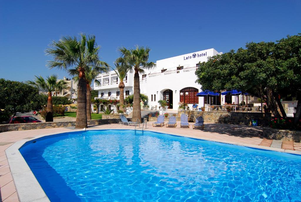 a large swimming pool in front of a hotel at Lato hotel in Agios Nikolaos