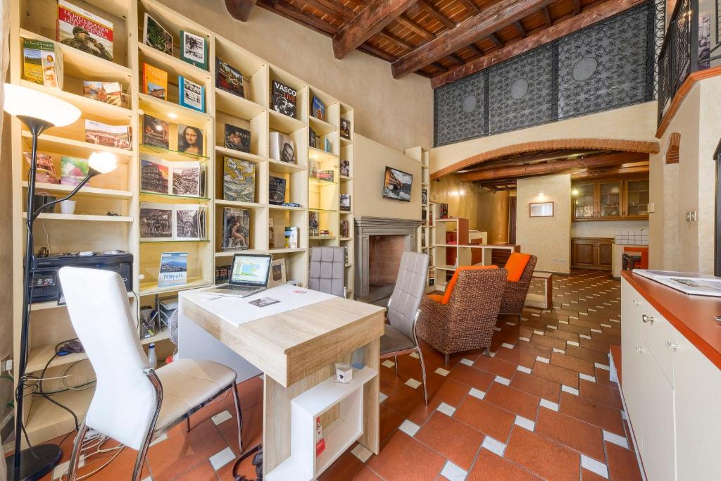 an office with a desk and chairs in a room at Home Boutique Santa Maria Novella in Florence