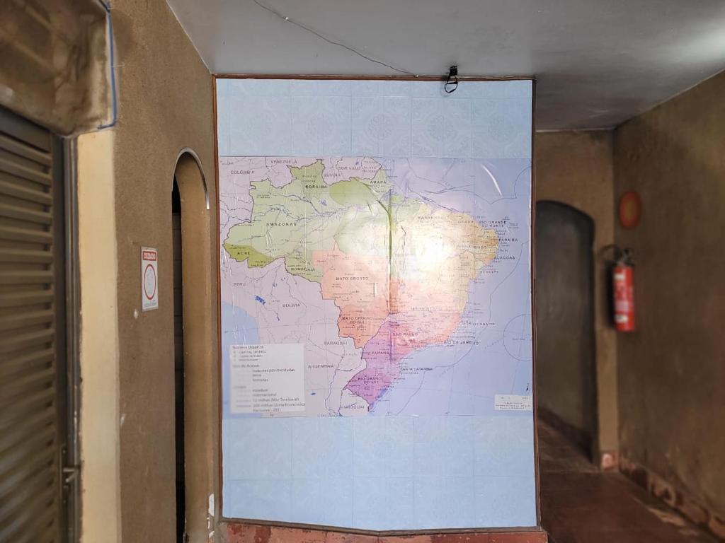 a map hanging on a wall in a hallway at Guest House BH in Belo Horizonte