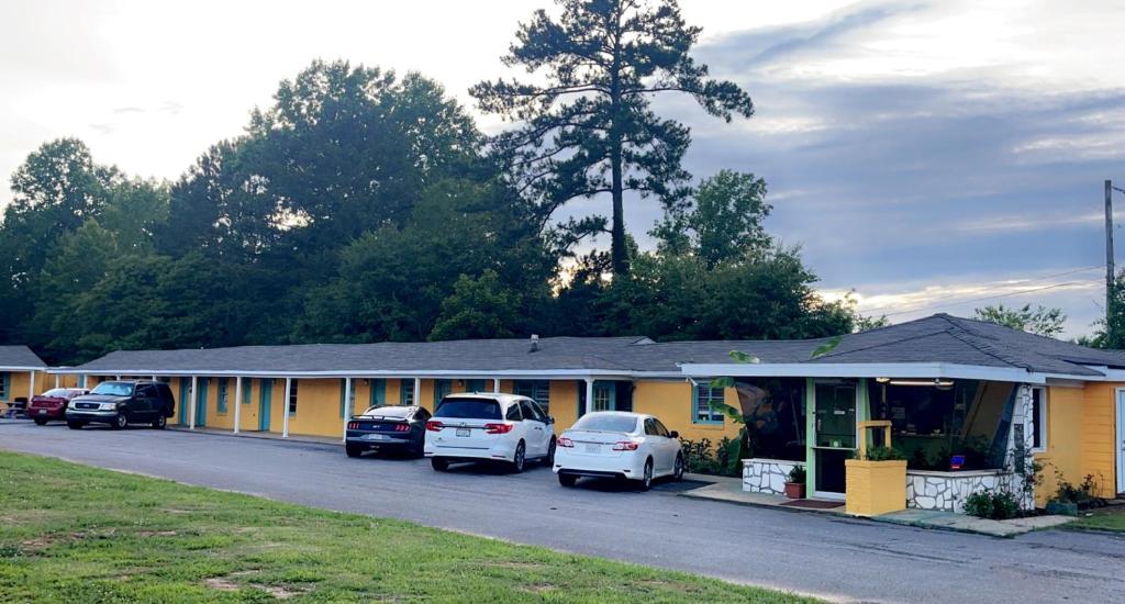 a row of houses with cars parked in front of them at LAMPLIGHTER INN in Childersburg