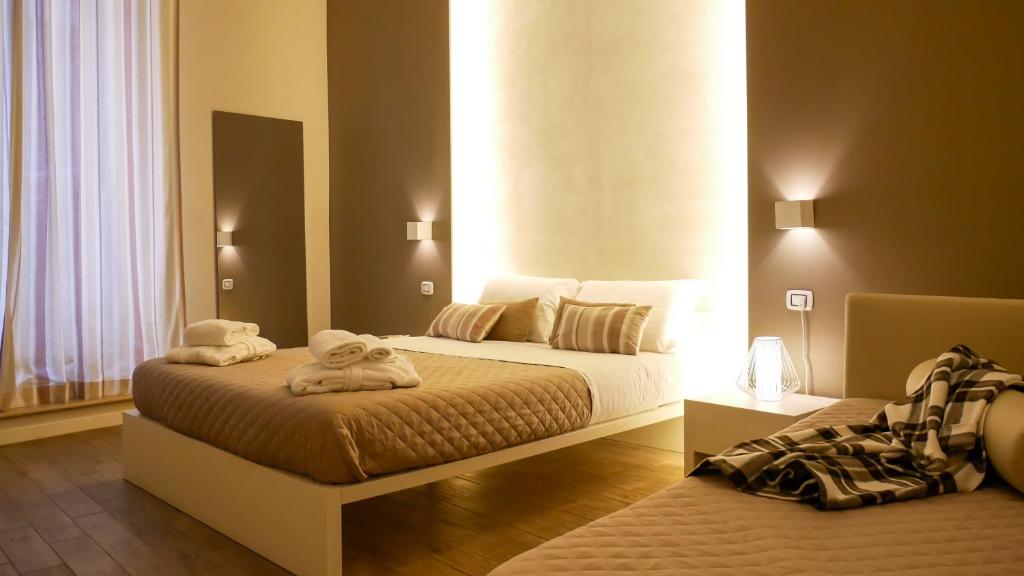 Ένα ή περισσότερα κρεβάτια σε δωμάτιο στο La Banchina Holiday Rooms