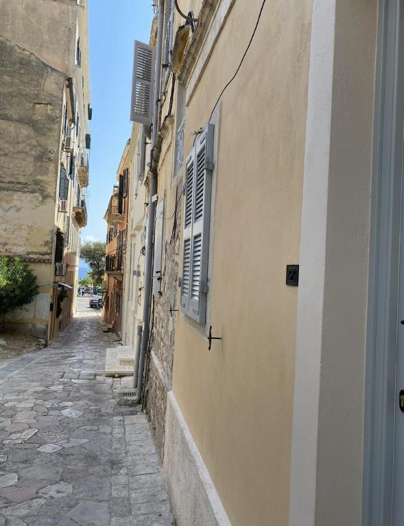 an alley in an old town with a building at Corfudodici in Corfu Town
