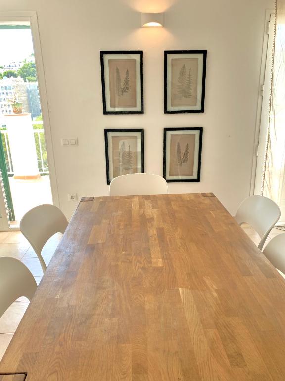 a conference room with a wooden table and chairs at Es Cucó in Cala Galdana