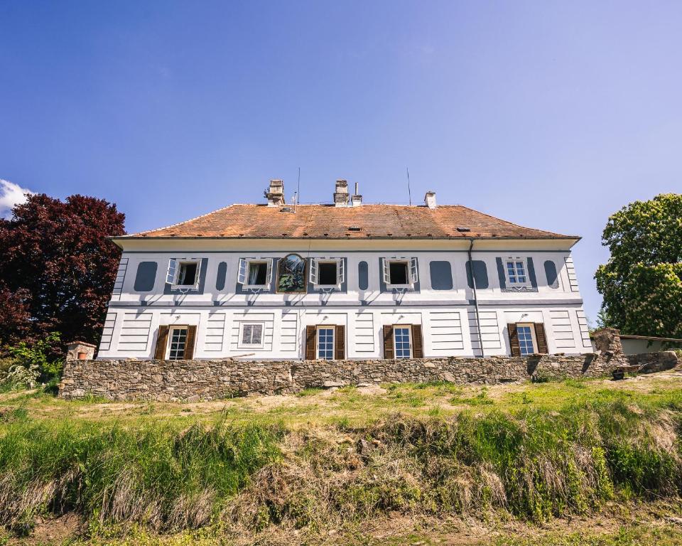 a large white house on top of a hill at Villa Waldhaus in Český Krumlov