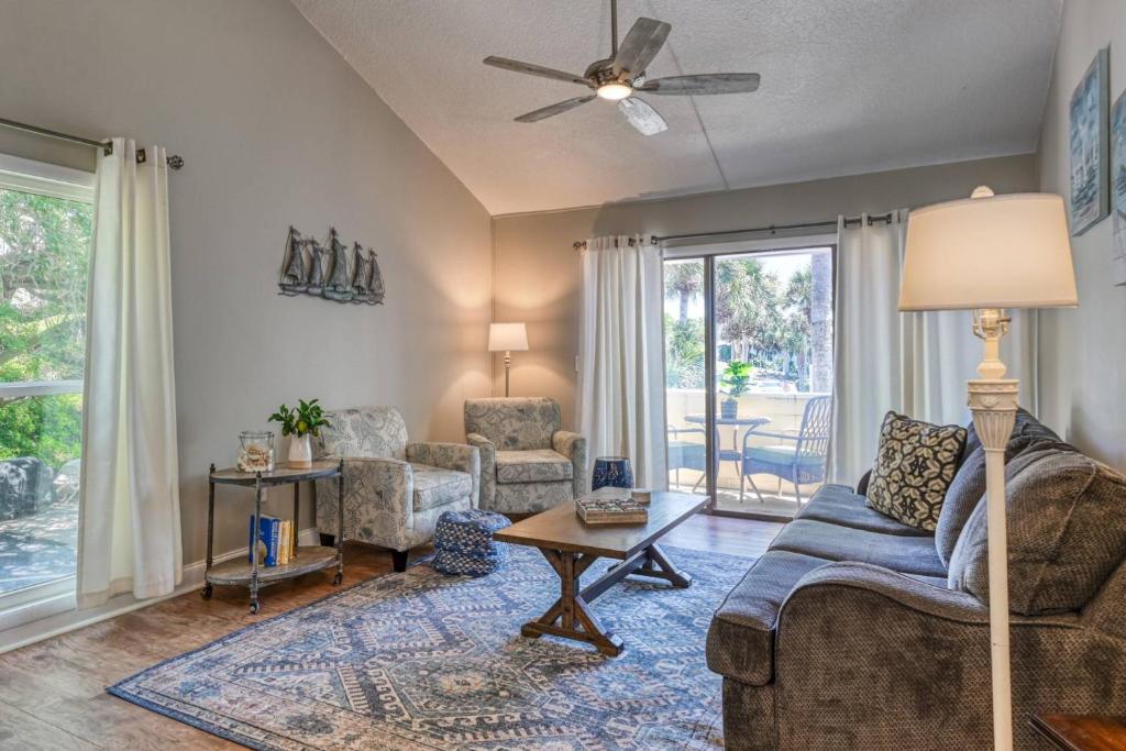 a living room with a couch and chairs and a table at Sea Turtle Shores in St. Augustine