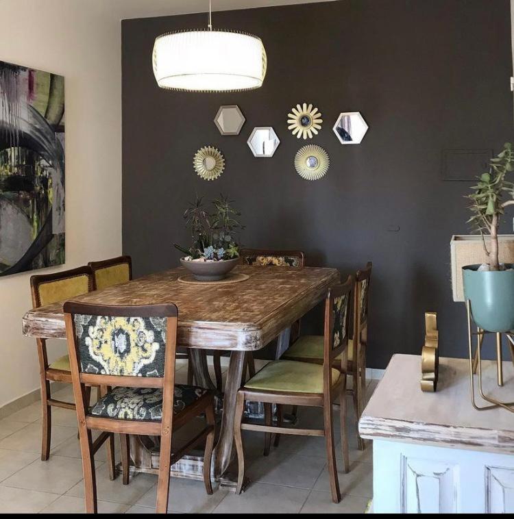 a dining room with a wooden table and chairs at Excelente depto sobre Bv Galvez in Santa Fe