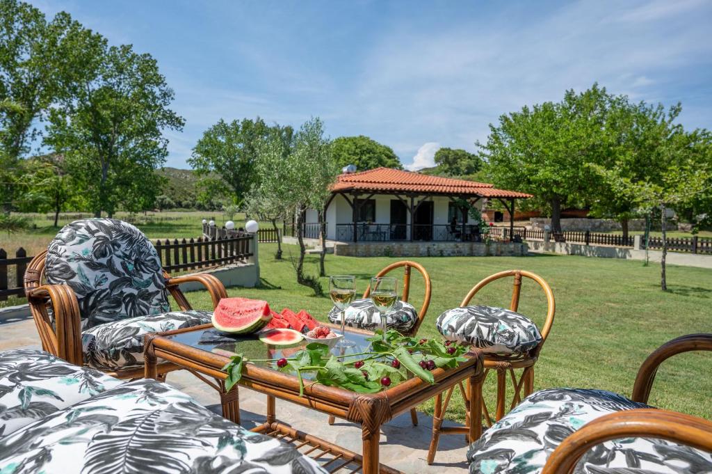 a table with fruits and vegetables on a patio at Exochiko Kalamitsi in Kalamitsi