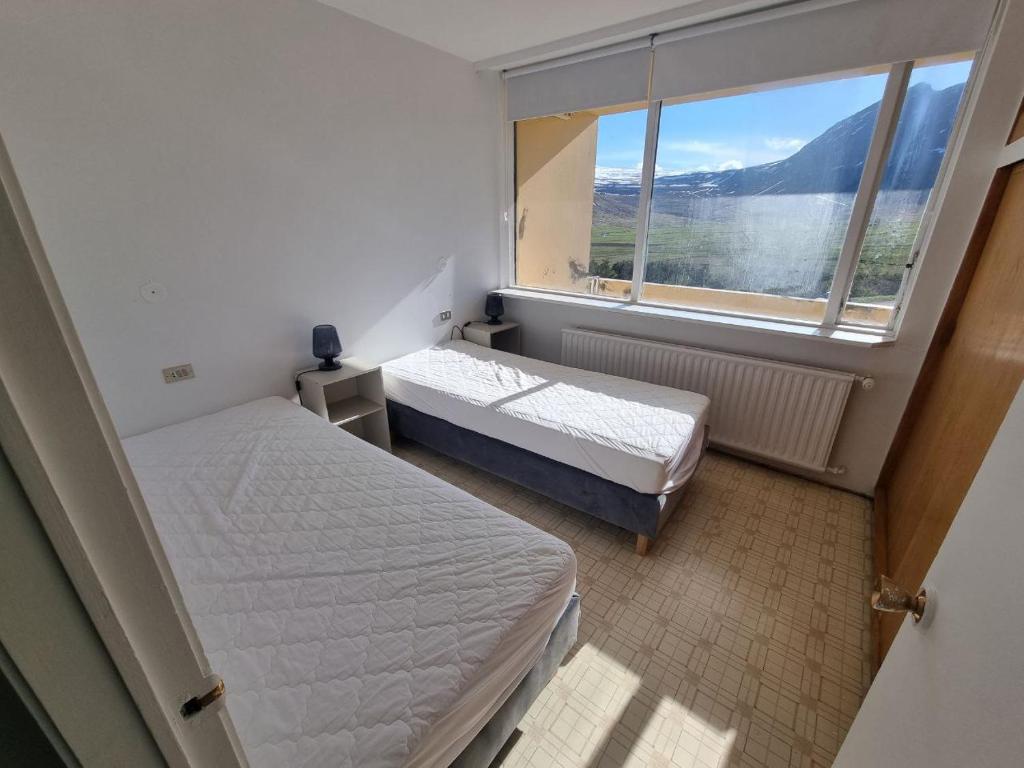 מיטה או מיטות בחדר ב-Dúfan Apartments