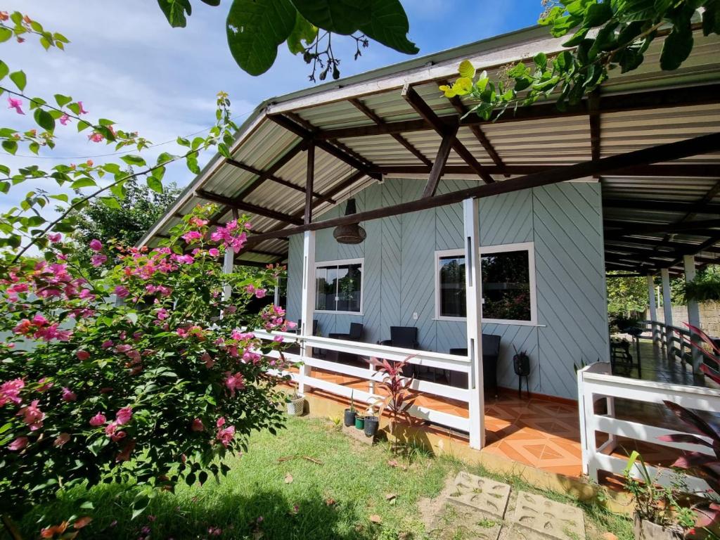 a tiny house with awning and a porch at Casa Apuaú in Novo Airão