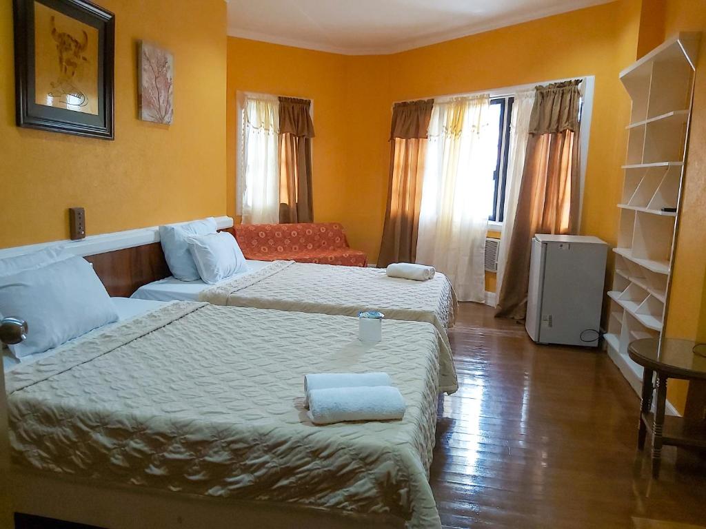 Postel nebo postele na pokoji v ubytování Stefanie Grace Paradise Inn