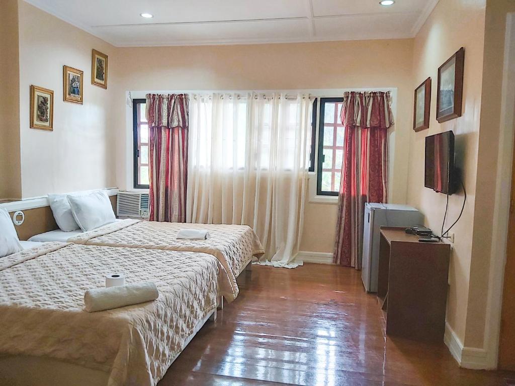 Postel nebo postele na pokoji v ubytování Stefanie Grace Paradise Inn