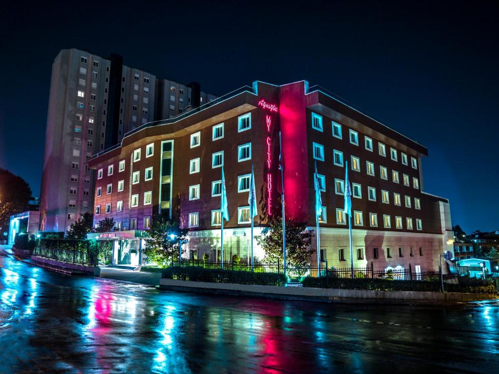 a building with red lights on the side of a street at Agaoğlu My City Hotel Istanbul in Istanbul