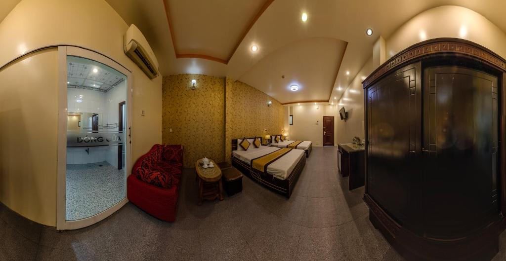 a large room with a bed and a bathroom at Dong Bao Hotel in Chau Doc