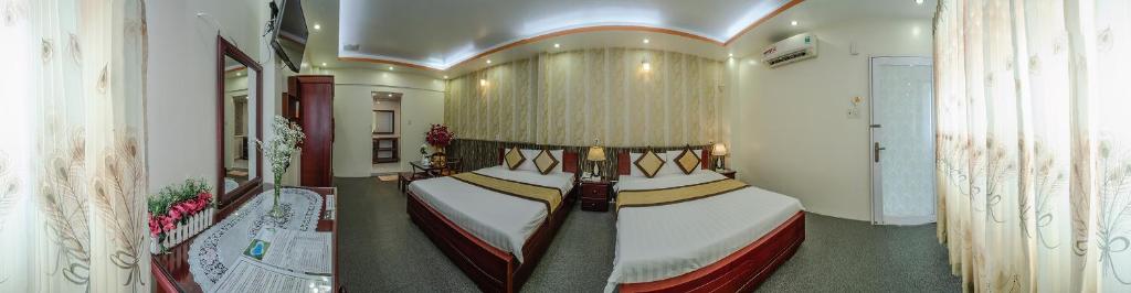 a bedroom with a large bed in a room at Dong Bao Hotel in Chau Doc