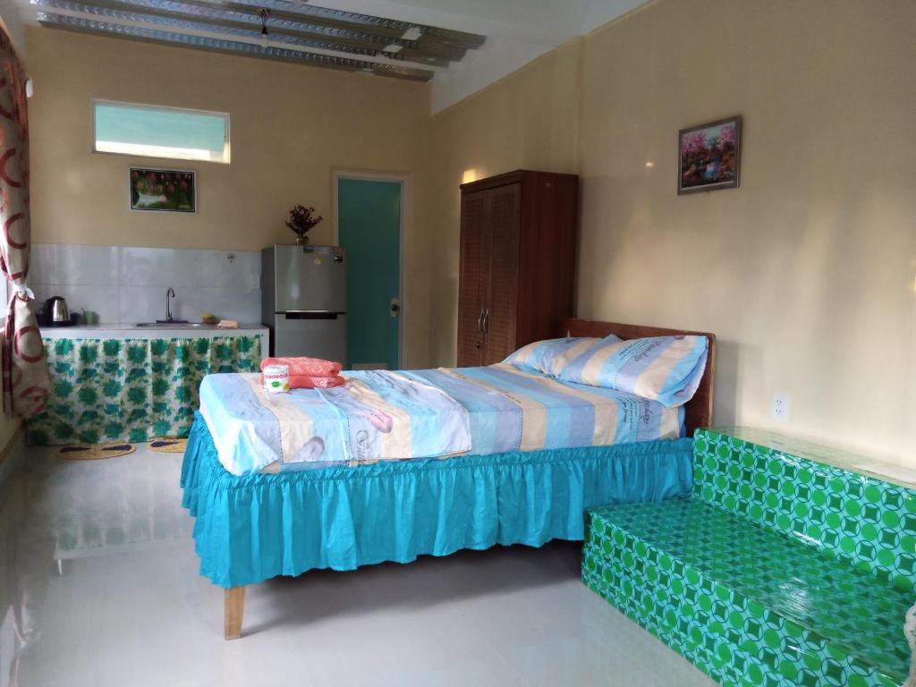 a bedroom with a bed and a couch at Lucky777 Homestay in Mambajao
