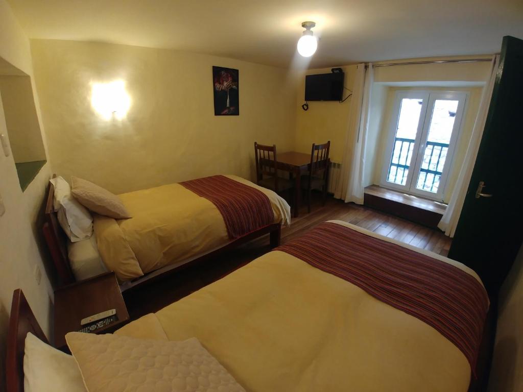 Postel nebo postele na pokoji v ubytování Hostal Corihuasi