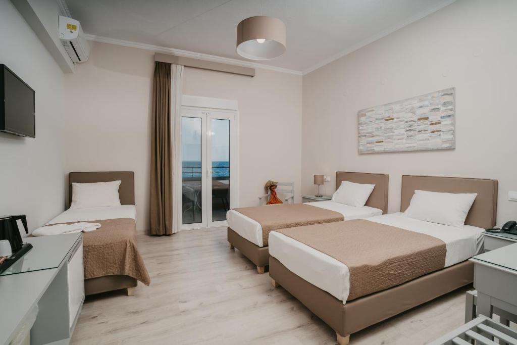 Postel nebo postele na pokoji v ubytování Hotel Alkyon