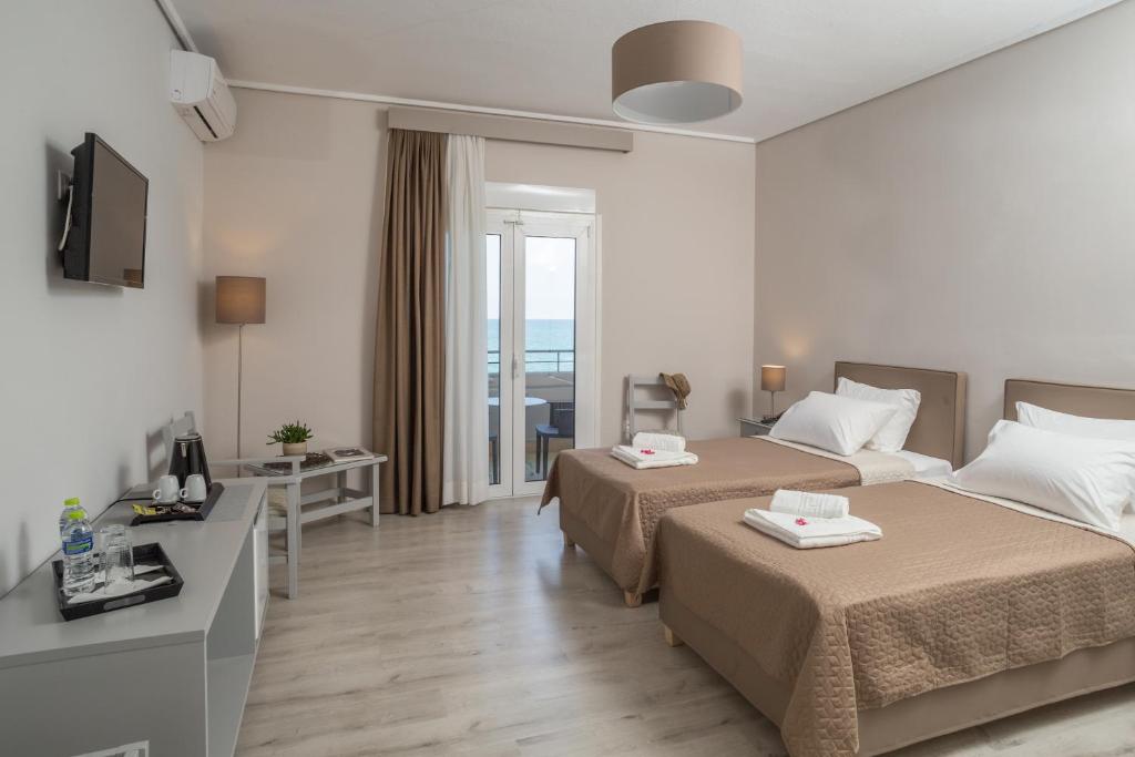 Postel nebo postele na pokoji v ubytování Hotel Alkyon
