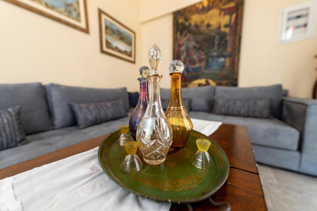 a table with three glass bottles on top of it at Villa Areto in Kamares