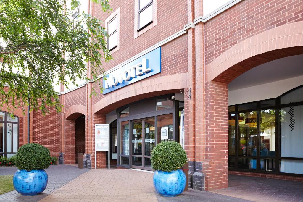 two blue vases in front of a brick building at Novotel Ipswich Centre in Ipswich